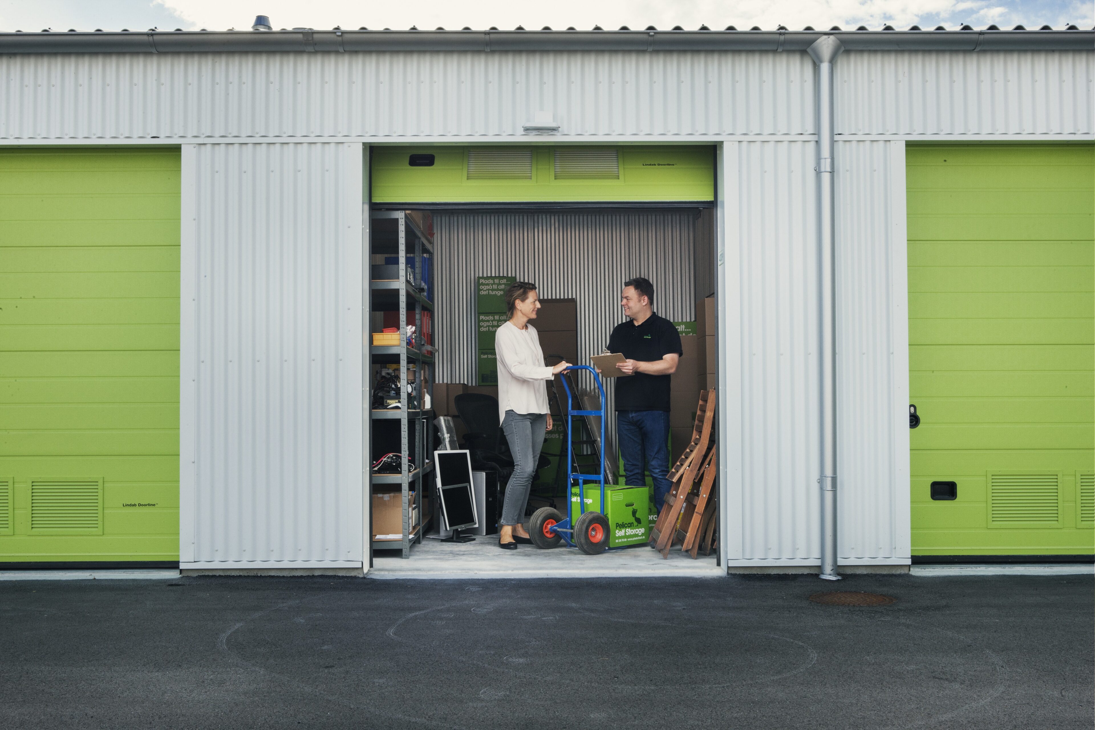 Storage unit with two people at Pelican Self Storage