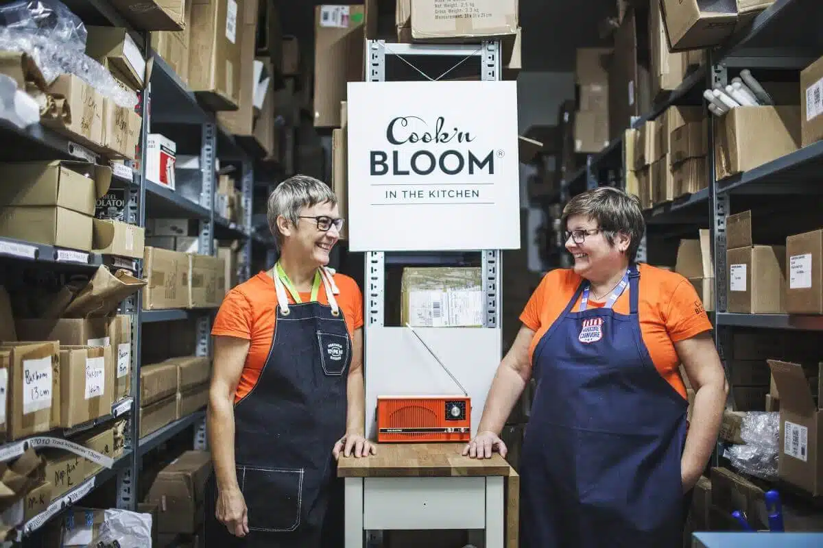 Two women by storage shelves